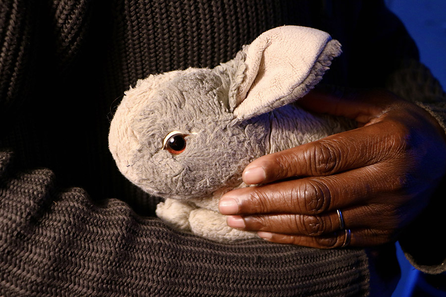 image for free online embracing grief taster event man lovingly holding soft toy rabbit